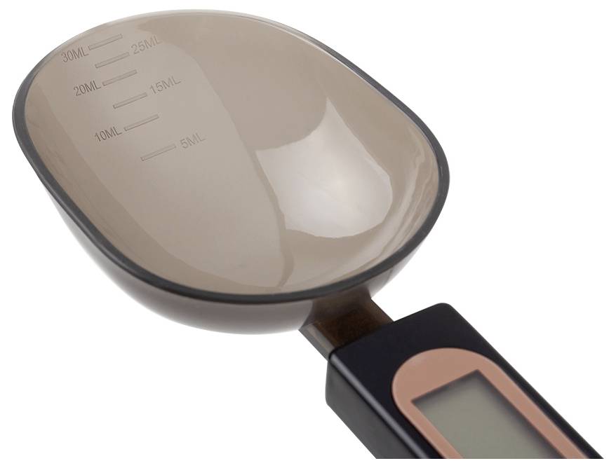 Close-up of a digital kitchen measuring scoop with a bowl marked in milliliters and a handle-mounted LCD display.