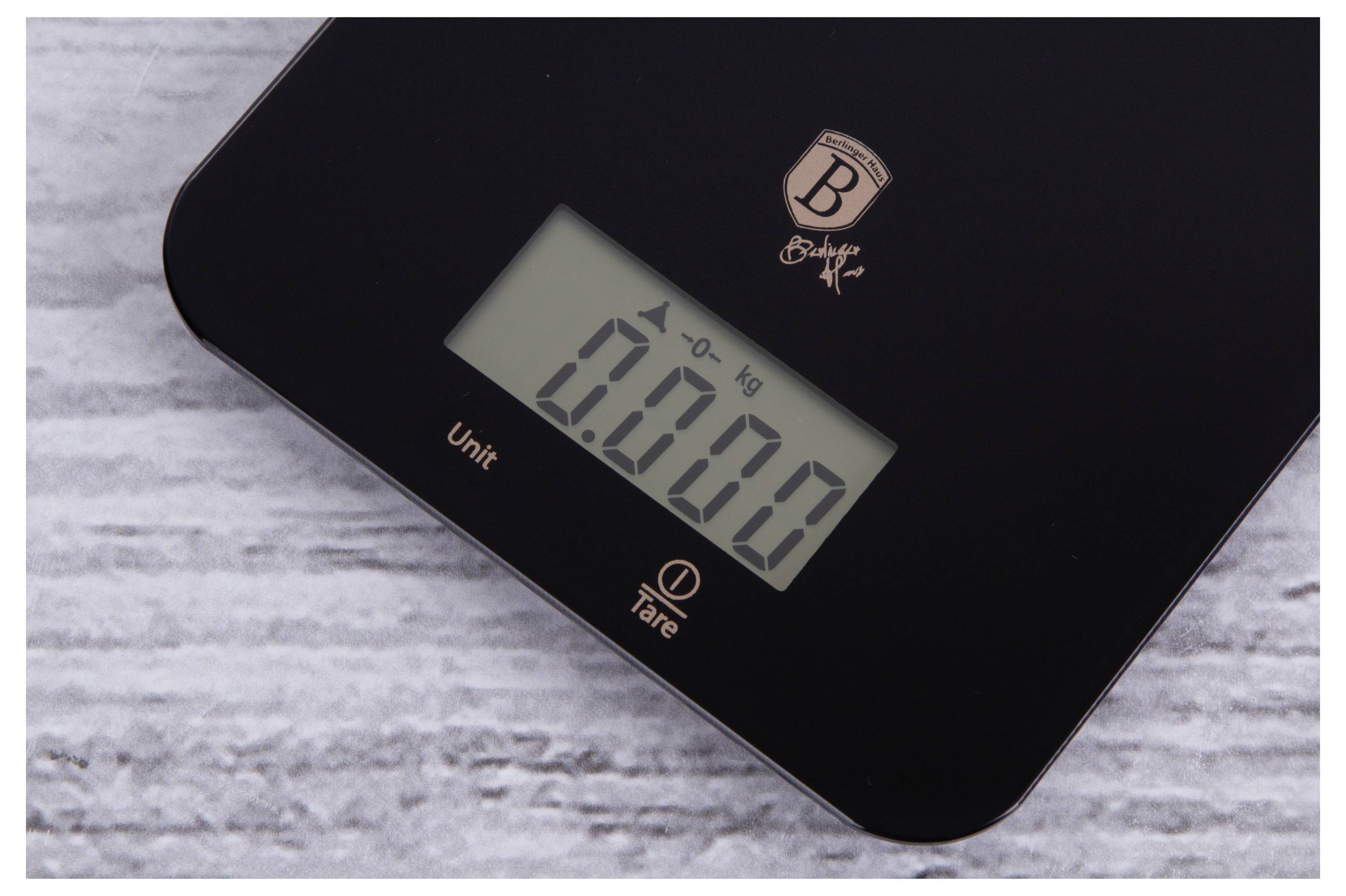 Digital kitchen scale showing 0.000 kg on its display, resting on a light marble surface.