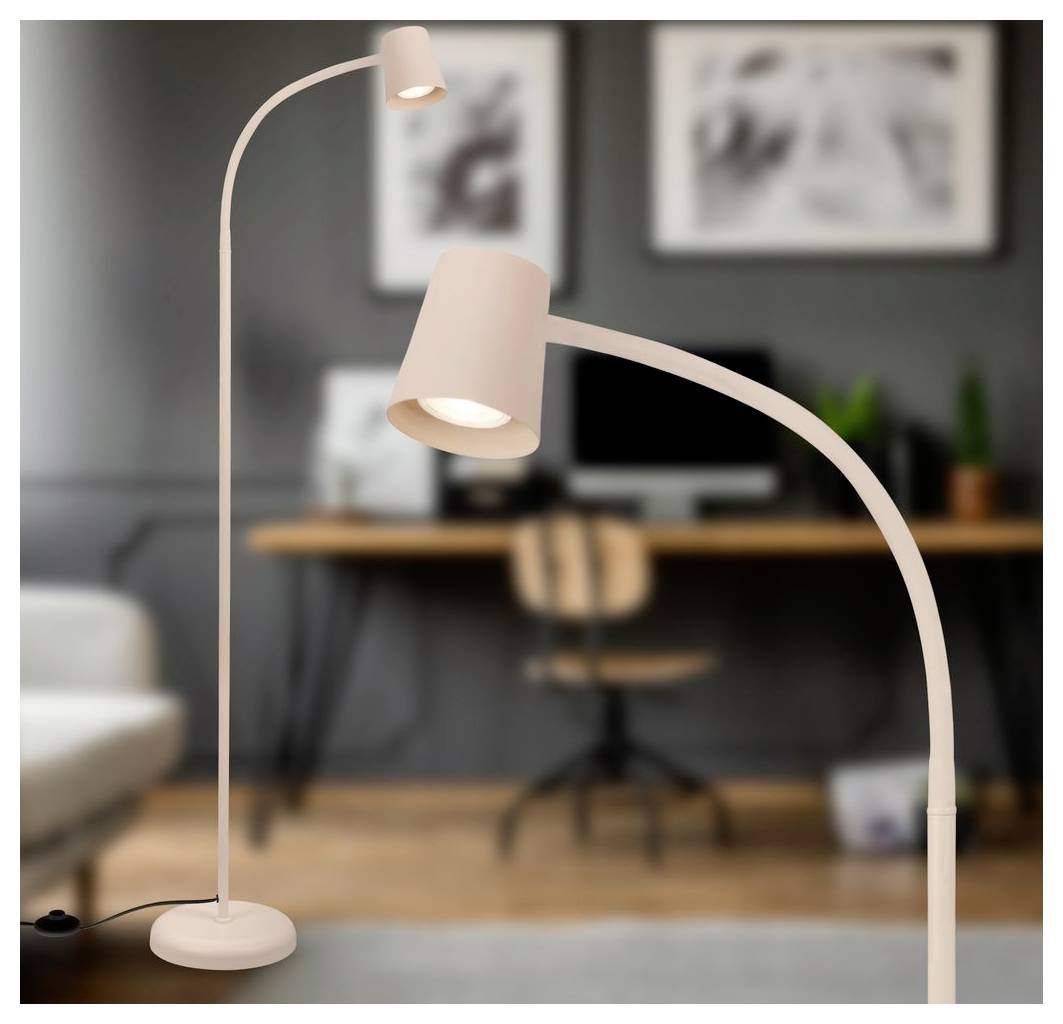 Modern beige floor lamp with two adjustable lights, shown in a home office or living room setting.
