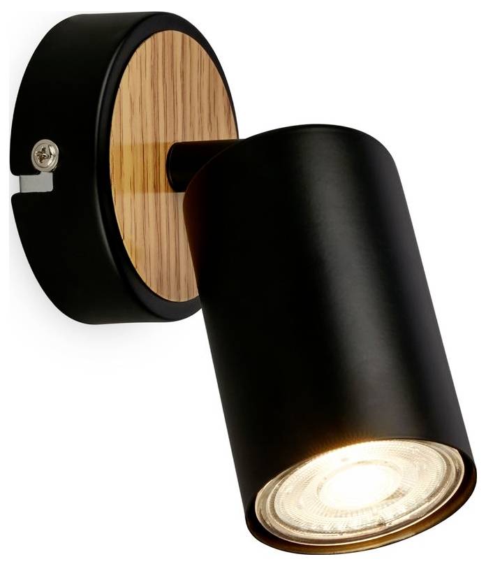Black adjustable wall spotlight with a wood backplate, shown lit and angled downward.