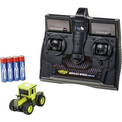 2.4 GHz RC controller with four AA batteries and a small green remote-control tractor toy on a white background