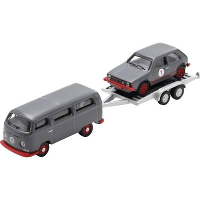 Gray toy Volkswagen van towing a gray toy car on a trailer, both with red accents, shown on a white background.