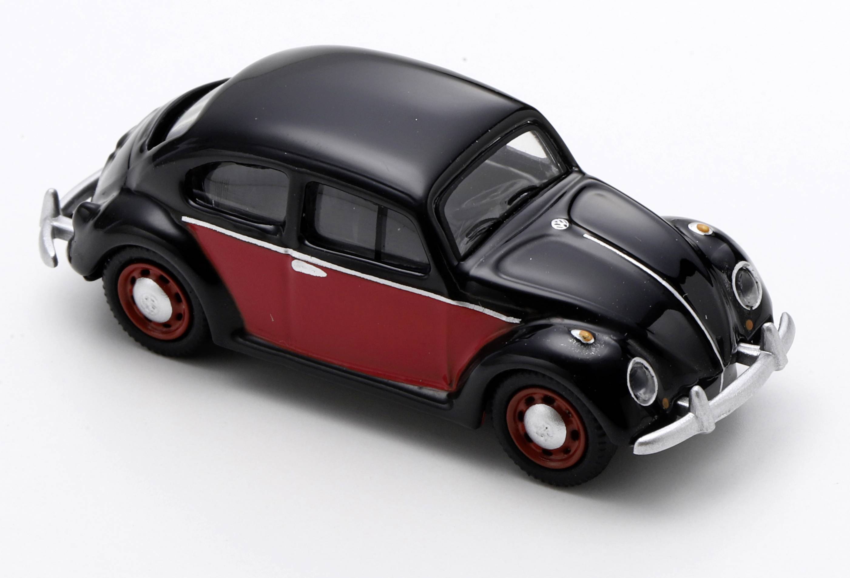 Black-and-red toy Volkswagen Beetle model shown on a white background<br>
