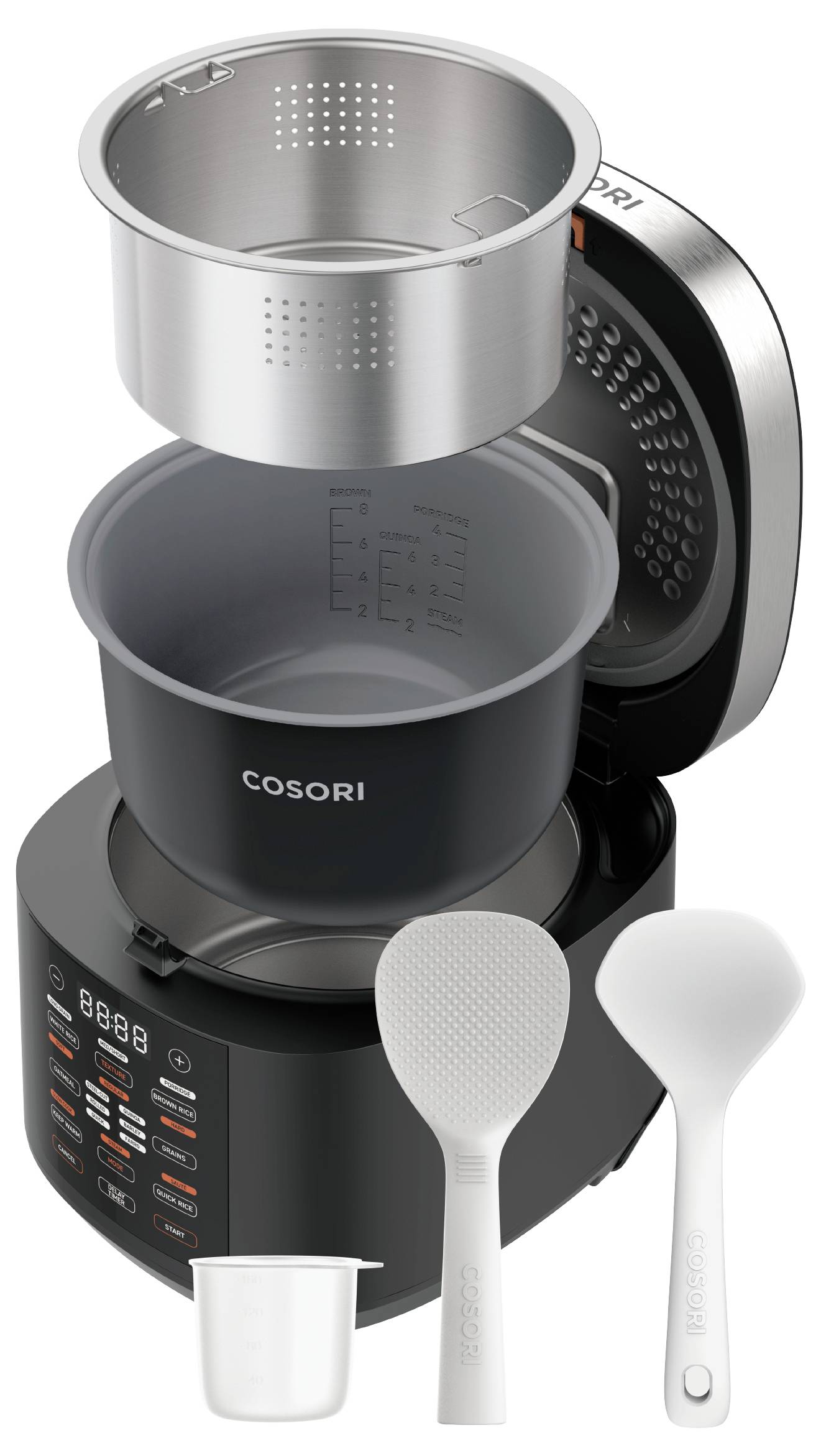 Air fryer with stacked accessory inserts and spoons, showing the main unit, perforated metal basket, and measuring cup on a white background.