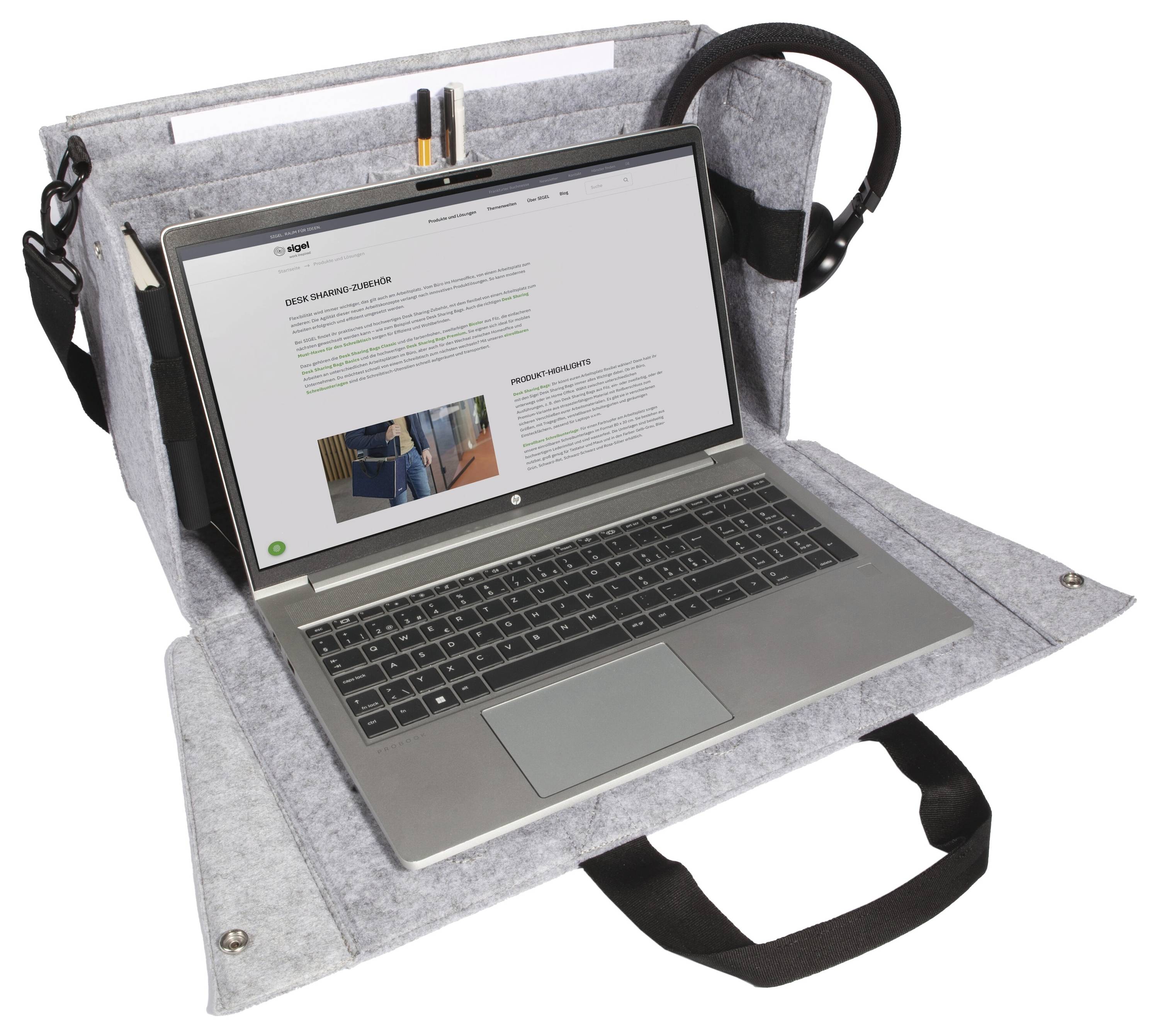 Laptop in a gray felt carry case with a front work flap, side pockets, and shoulder strap, used for portable protection and storage.
