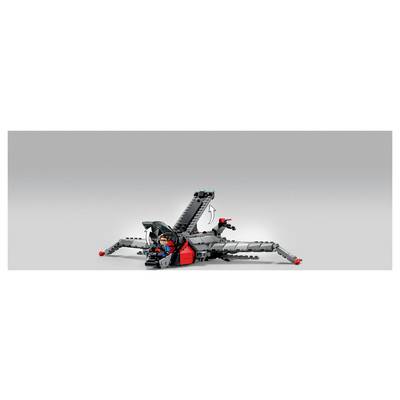 A LEGO-like spider robot with gray legs and red accents sits on a plain light background, with a seated pilot in the center and a raised rear arm.