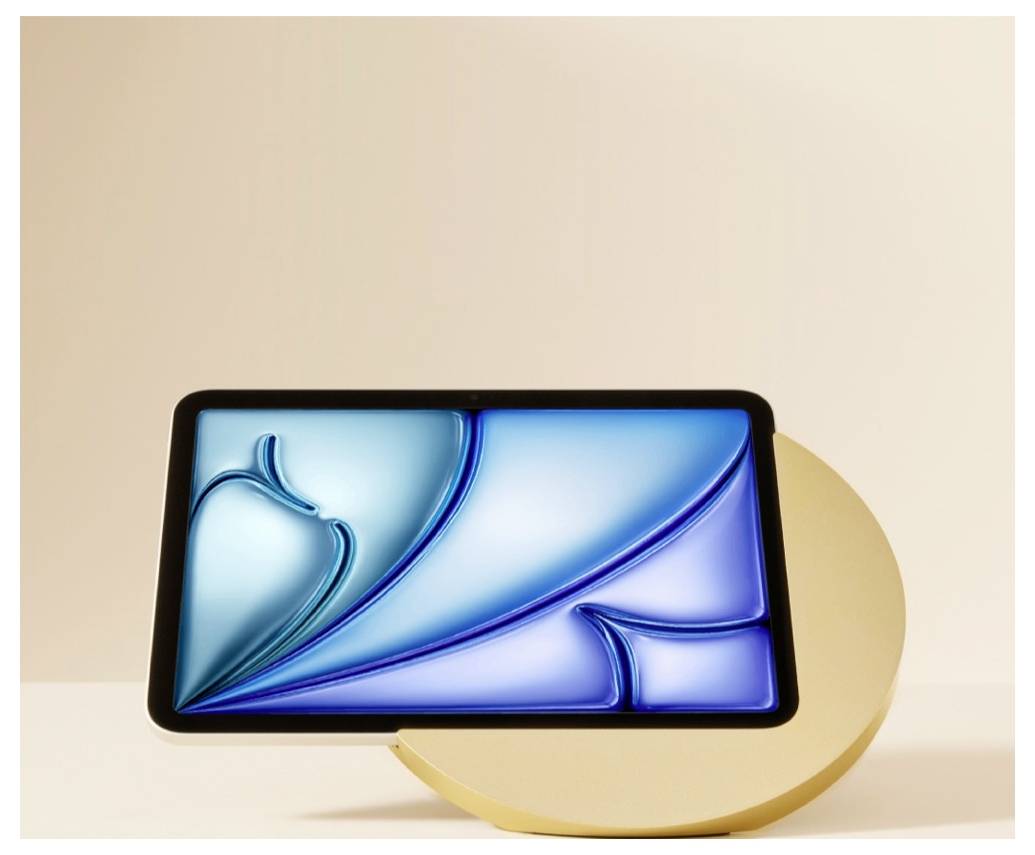 A tablet with a blue abstract screen rests on a gold circular stand against a beige background.