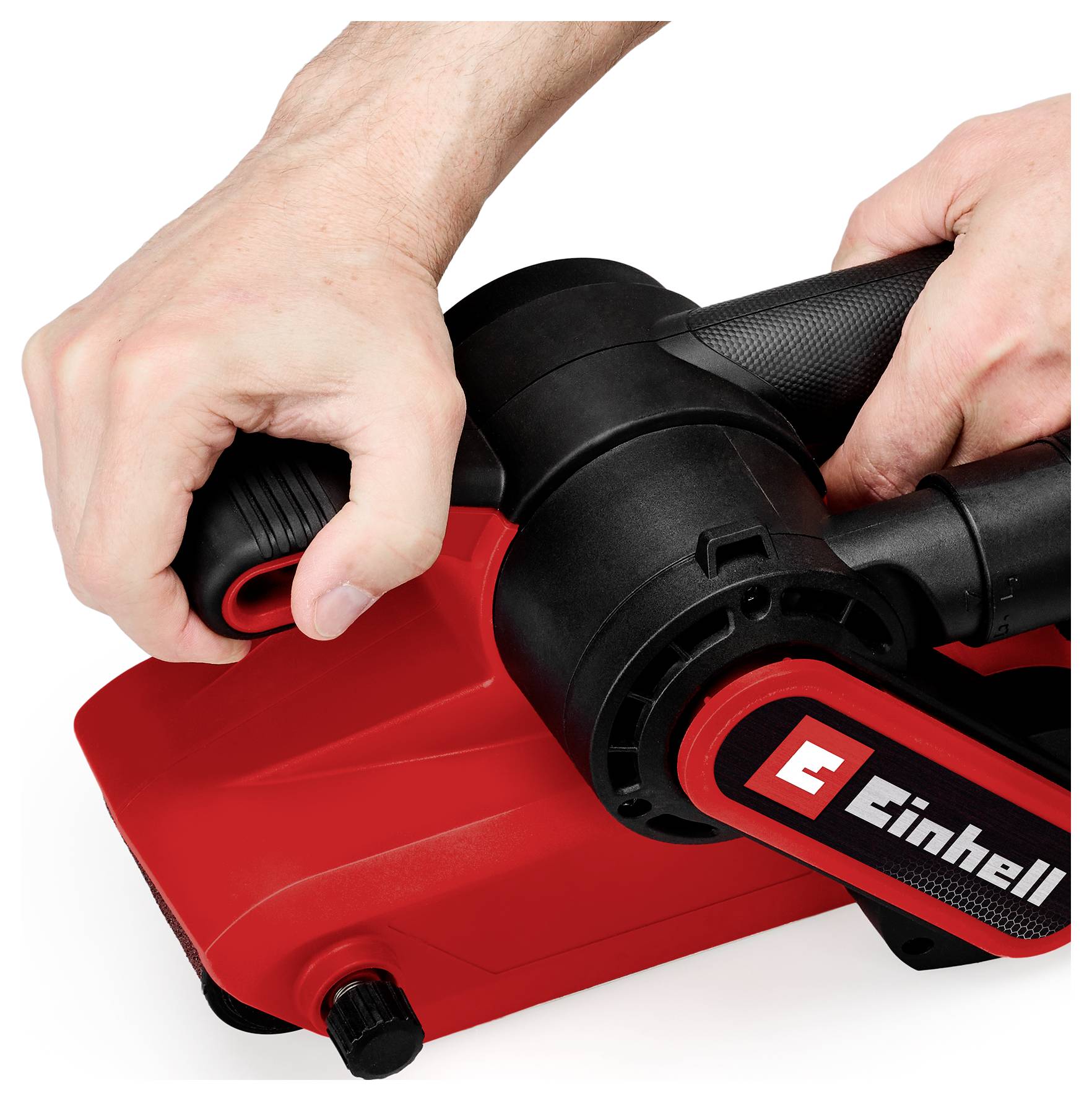 Hands adjusting a red and black Einhell power tool with a side handle on a white background.<br>