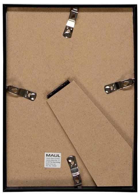 Back of a framed picture with cardboard backing and metal spring clips holding it in place, plus a hanging wire loop at the top.