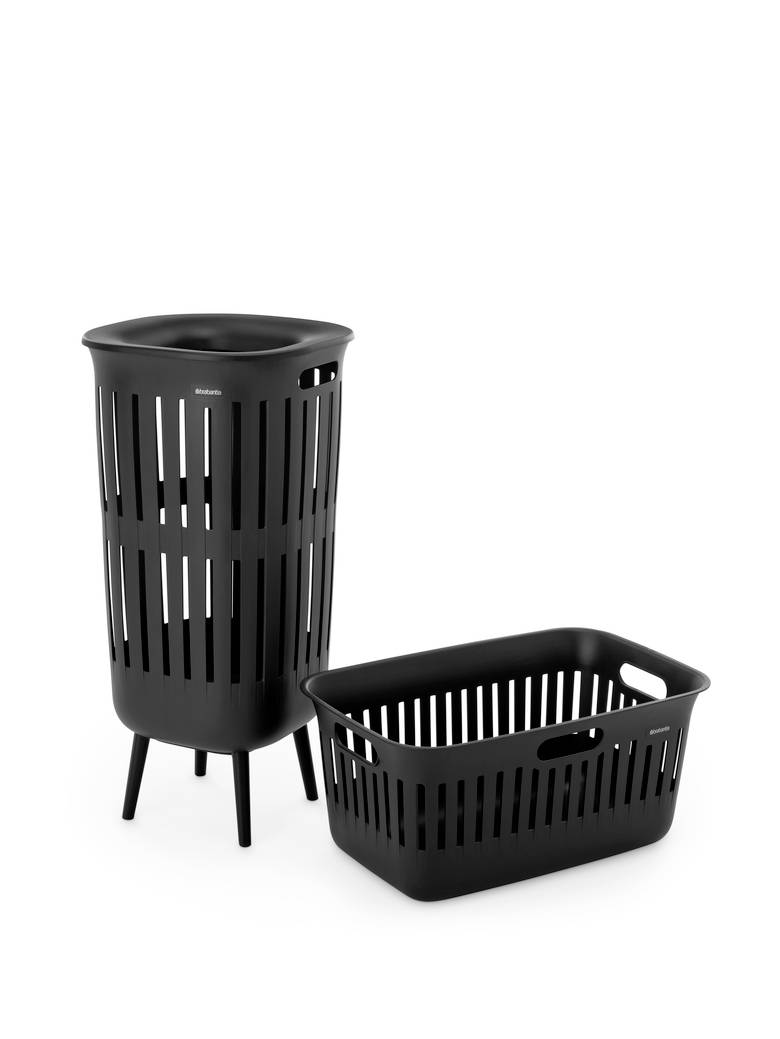 Black perforated laundry hamper and matching basket on a white background.