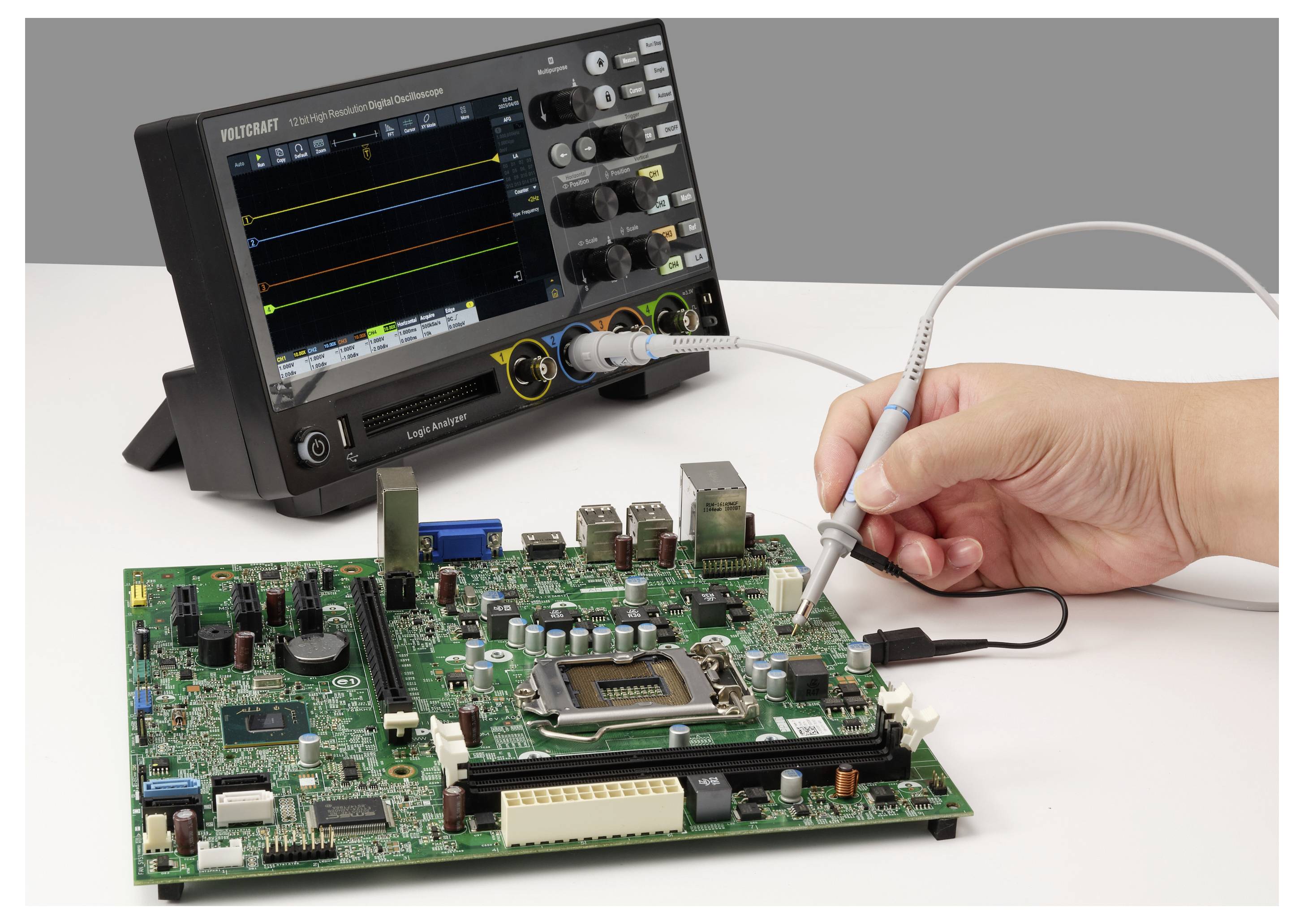 Hand probing a circuit board with an oscilloscope test lead while a digital oscilloscope displays signal traces in the background.