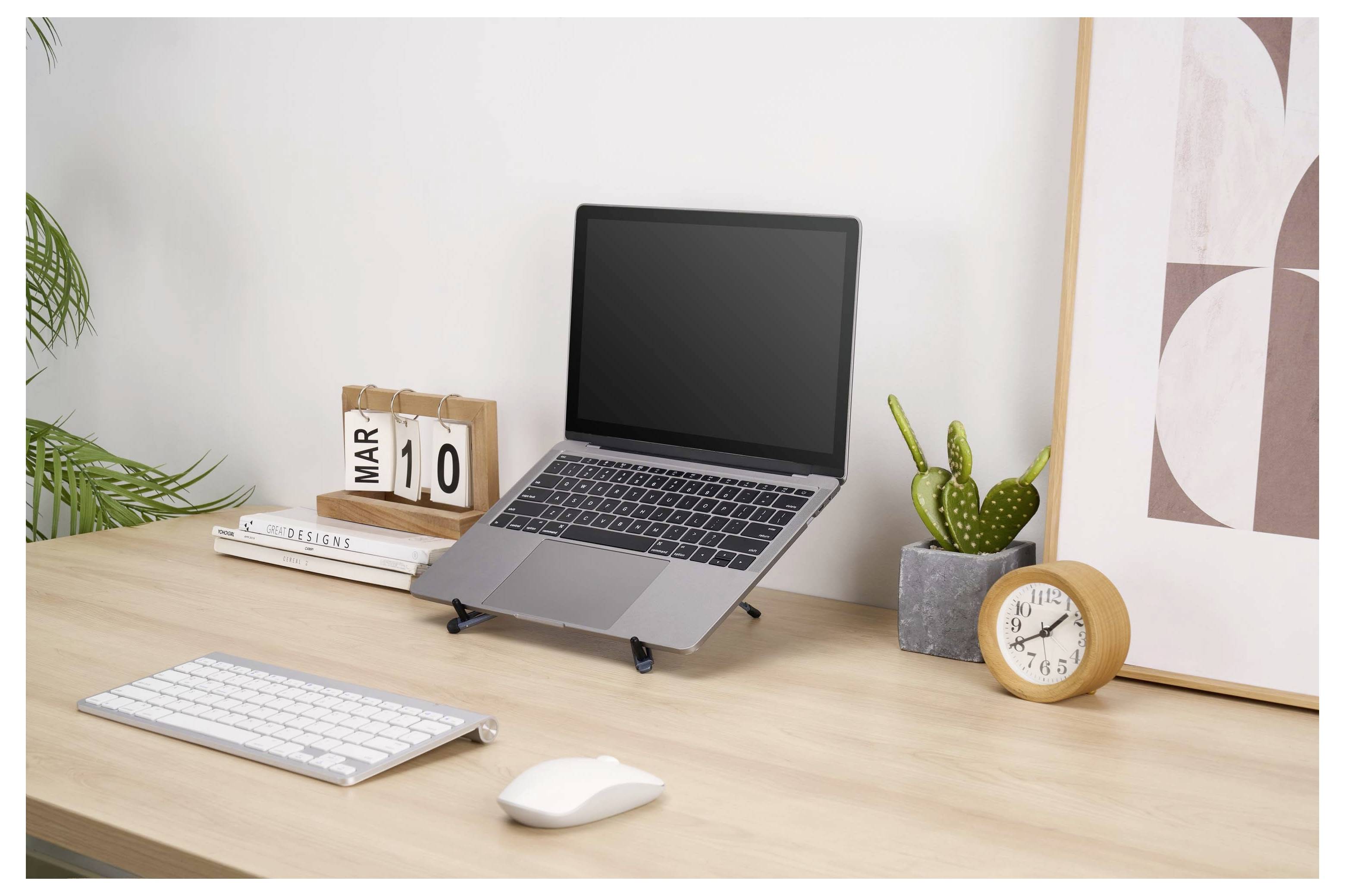 A minimalist home office desk with a laptop, keyboard, mouse, desk calendar showing Mar 10, books, a plant, and a clock.