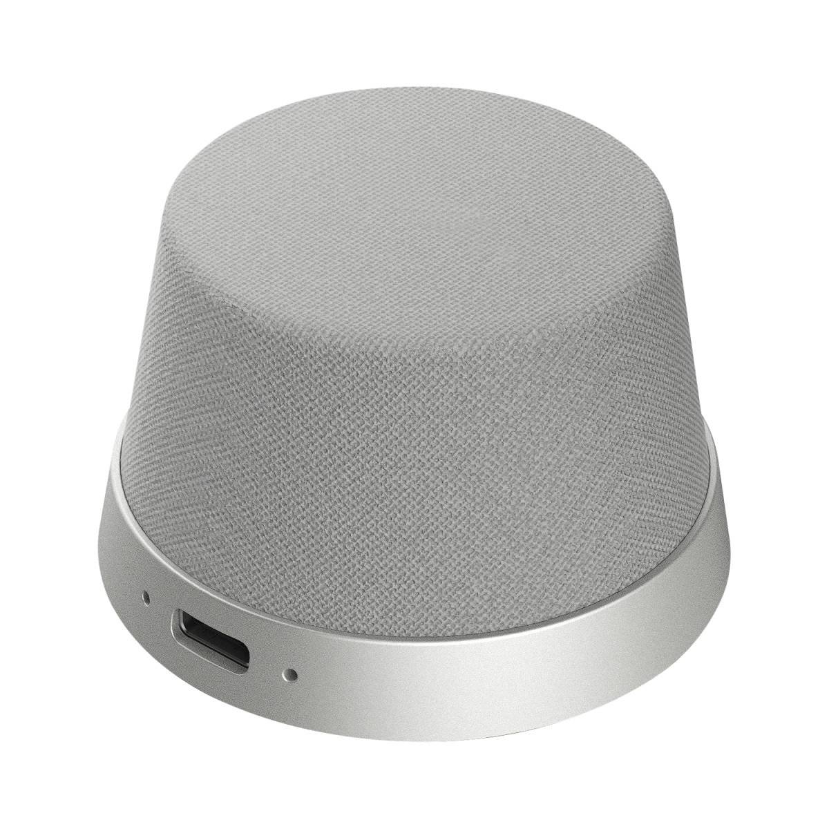 Gray fabric-covered smart speaker or wireless device with a silver base and USB-C port.