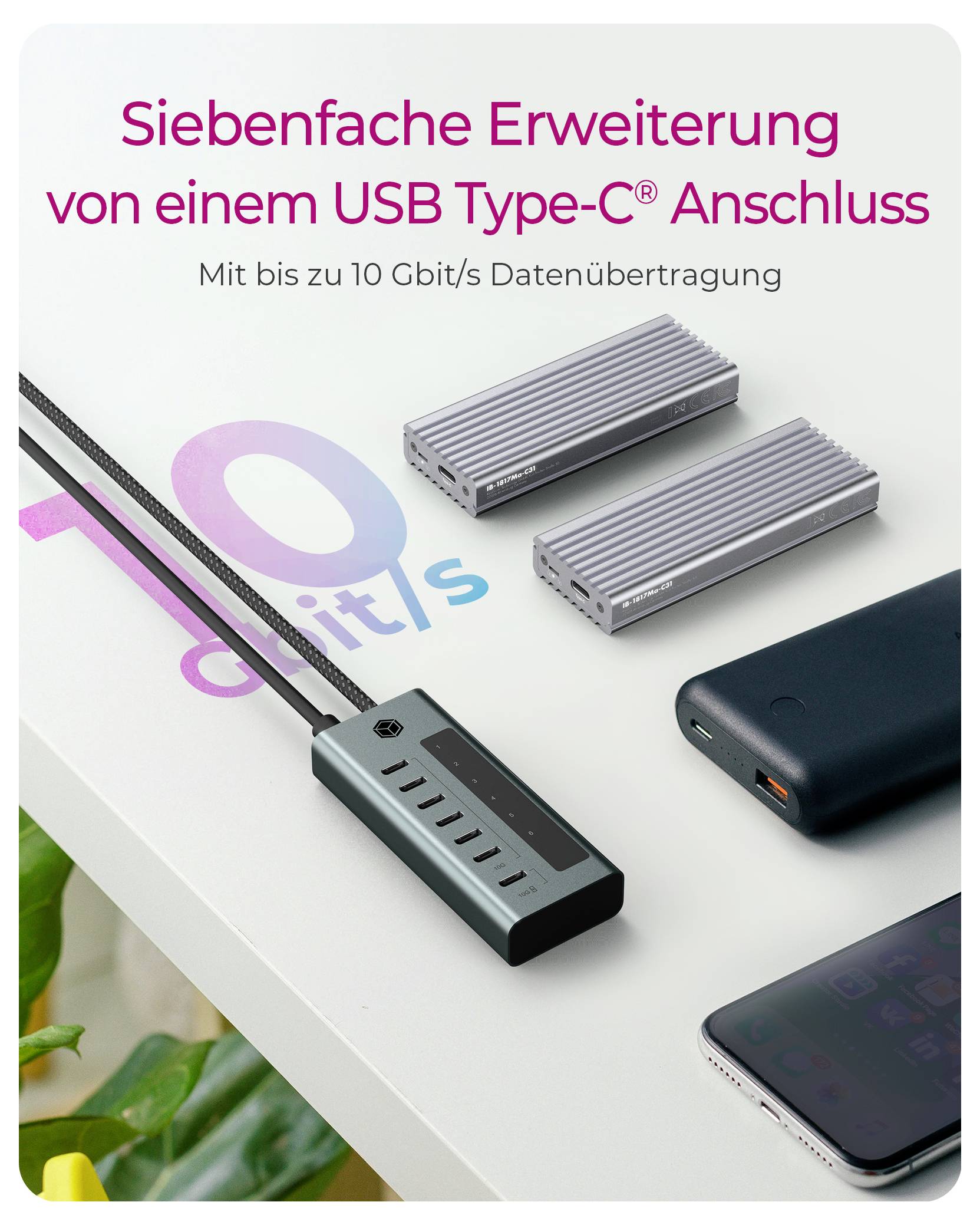 Promotional image of a USB Type-C hub, showing sevenfold expansion and up to 10 Gbit/s data transfer, with connected devices and accessories on a desk.