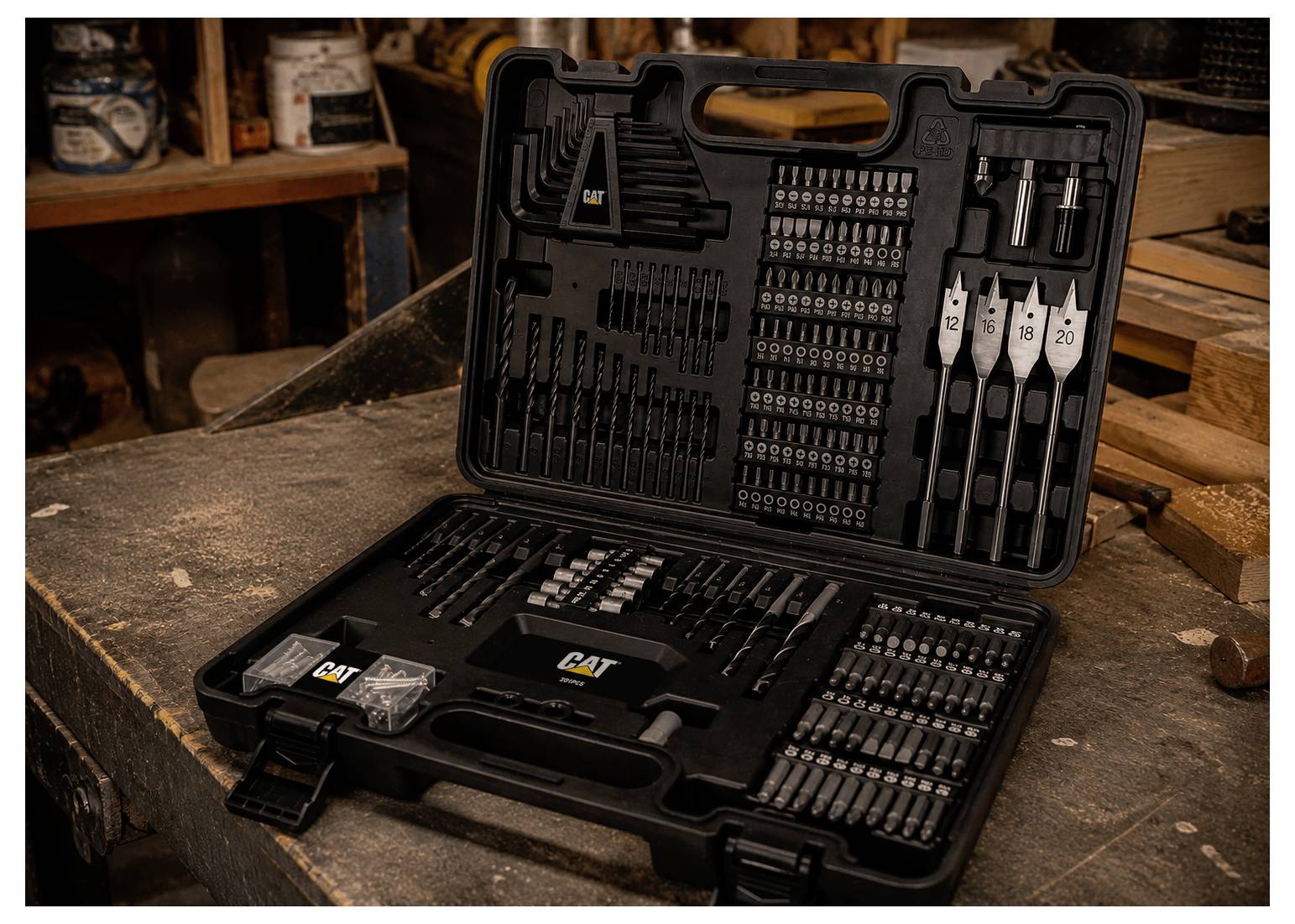 Open tool case with CAT drill and driver bit set, neatly organized on a workbench in a workshop.
