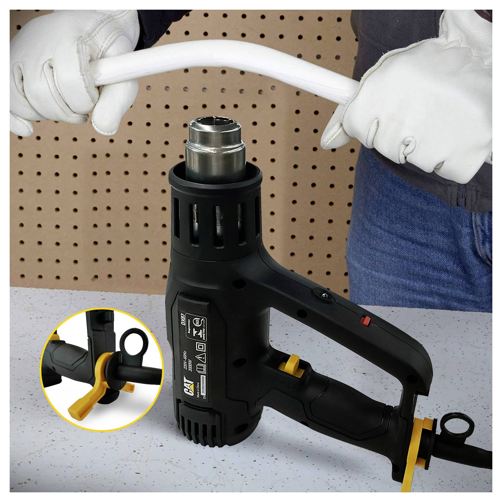 Person bends a white plastic pipe with a handheld heat gun, shown with a close-up inset of the tool's trigger and handle.