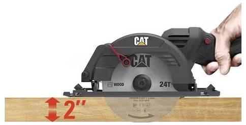Hand holding a CAT circular saw cutting a 2-inch-deep groove in a wooden board.
