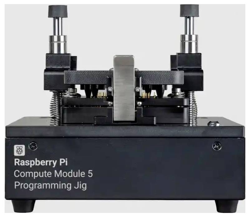 Raspberry Pi Compute Module 5 programming jig with clamp mechanism and labeled front panel for programming the module.