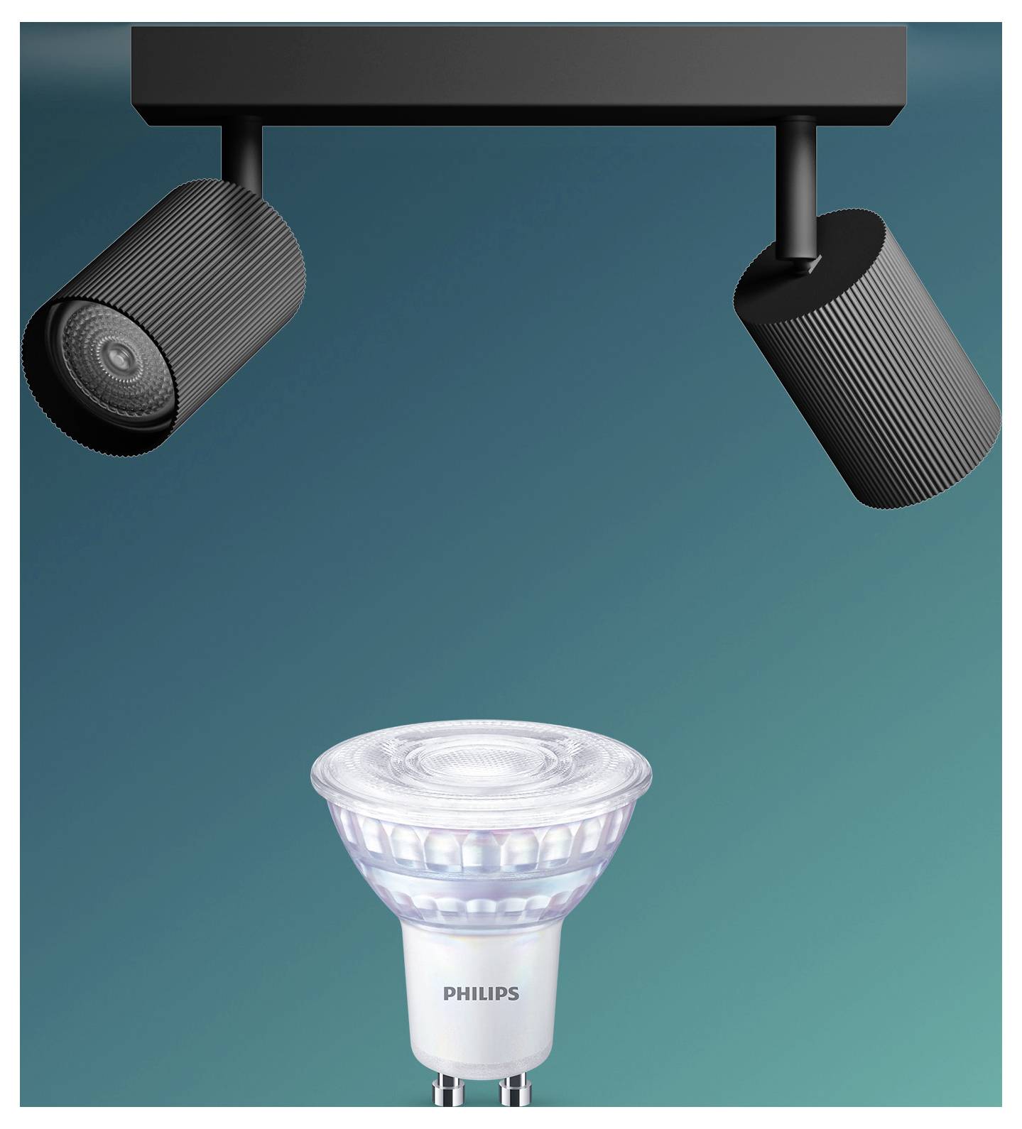 Two black track lights shine on a Philips spotlight bulb against a teal background.