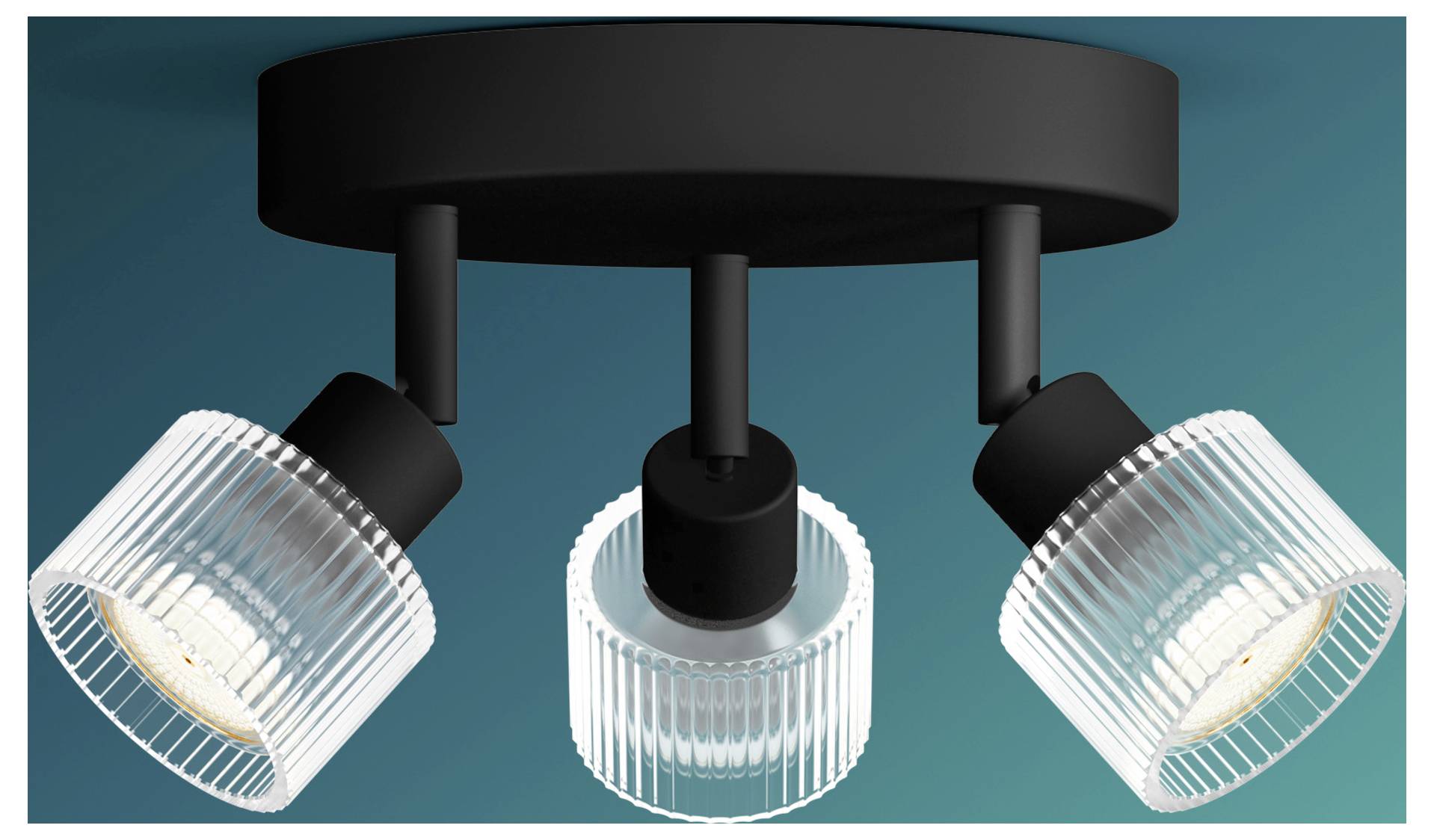 Three-bulb ceiling spotlight fixture with adjustable ribbed glass shades on a black round mount against a teal background.