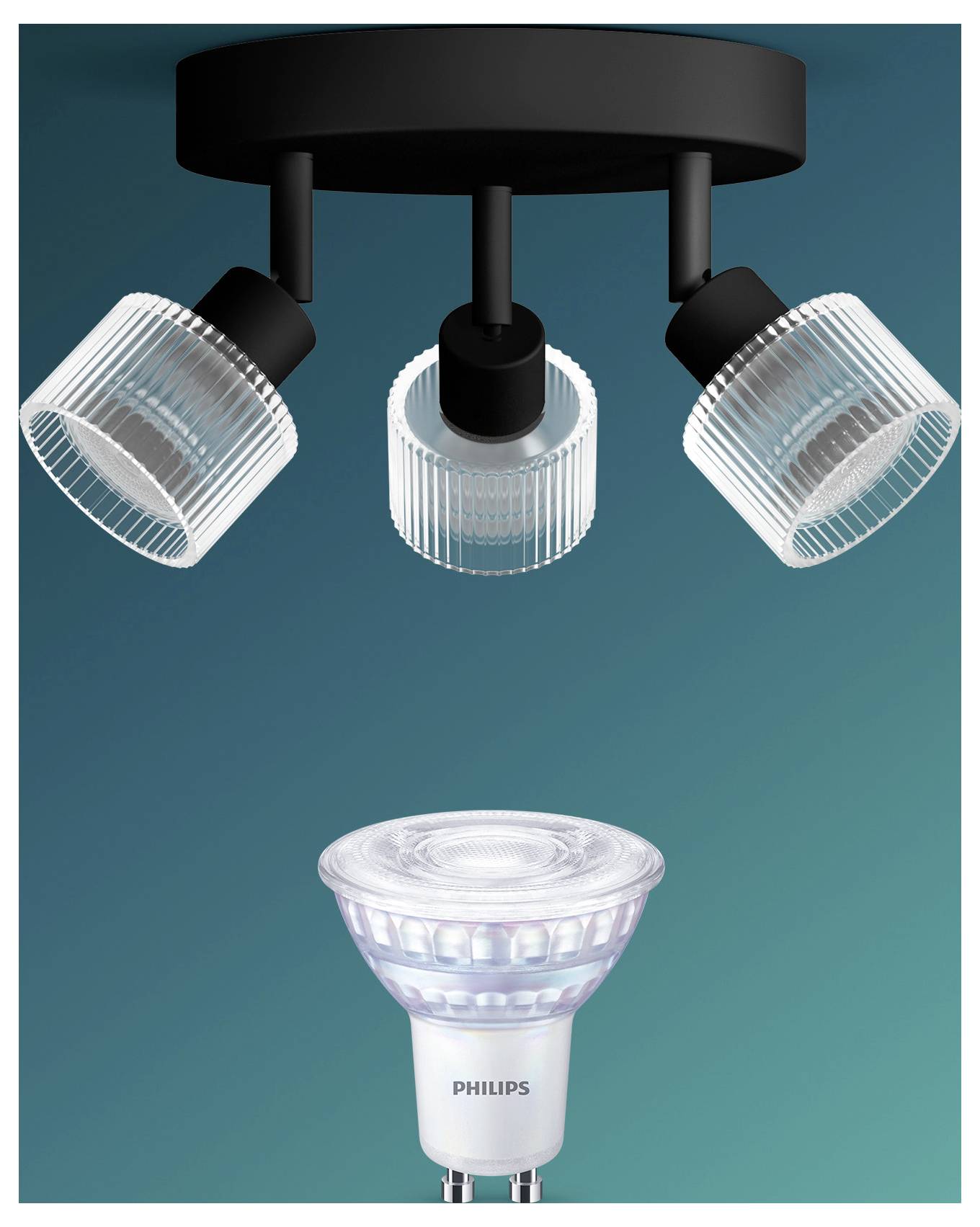 Three adjustable ceiling spotlights shine down on a Philips spotlight bulb shown below on a teal background.