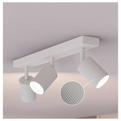 White three-light track ceiling fixture with adjustable ribbed cylindrical spotlights on a pale pink ceiling; inset shows close-up of the textured shade.<br>