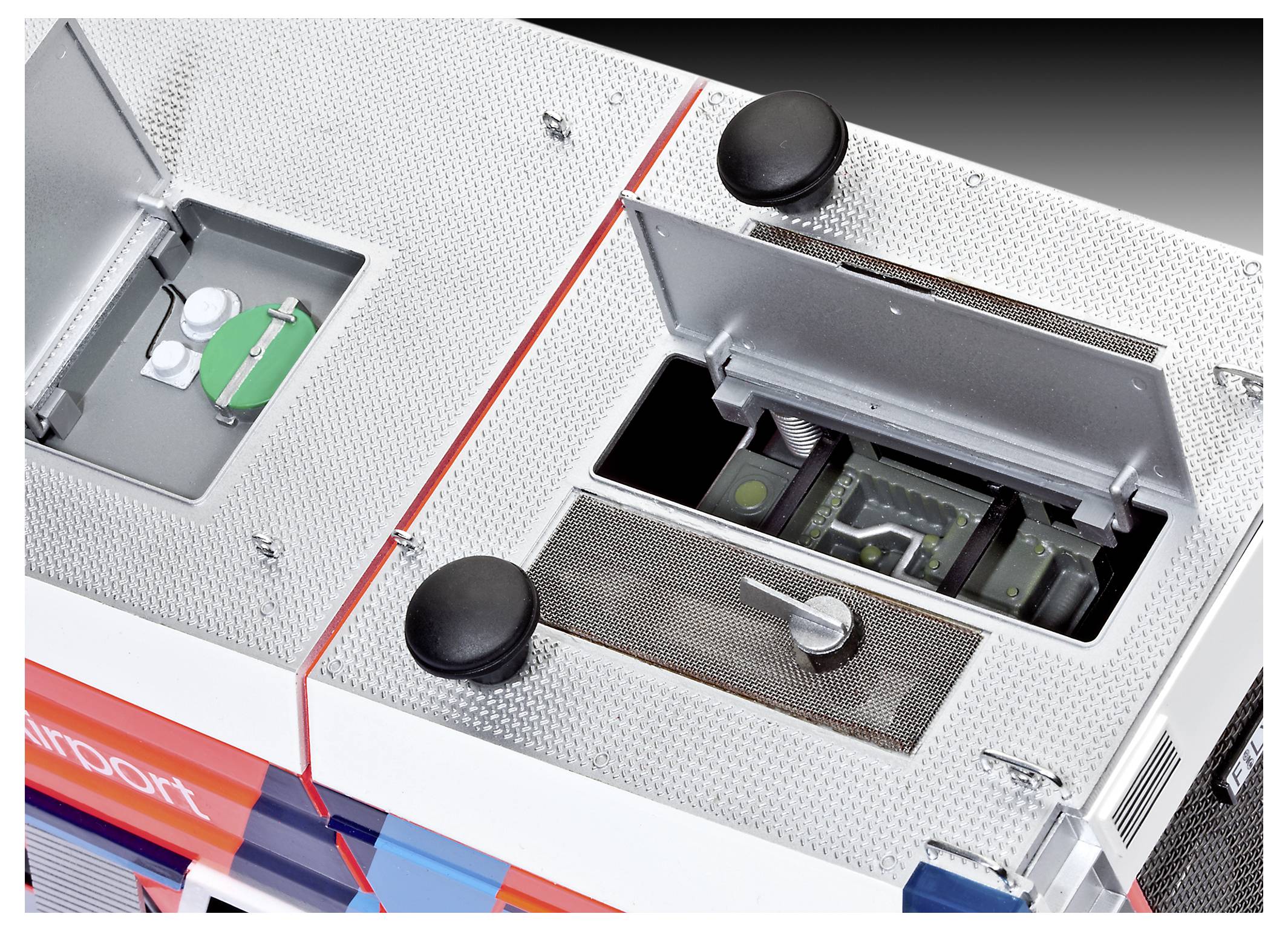Close-up of the top of a bus, showing open roof hatches and ventilation or access panels.