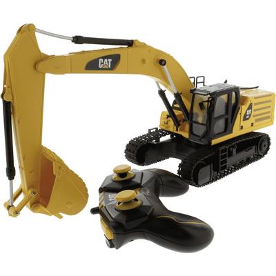 Yellow CAT remote-controlled excavator toy with black controller on a white background.