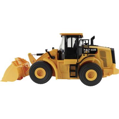 Yellow CAT 950M wheel loader with front bucket on a white background, shown in side view.