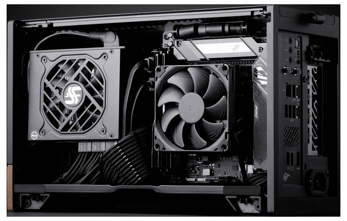 Open desktop PC case showing internal components, including two fans, a graphics card, and neatly routed cables.