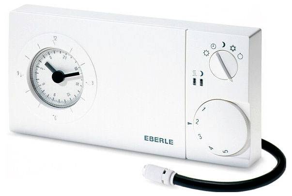White EBERLE thermostat with analog clock and two control dials, shown with a connected black sensor cable.