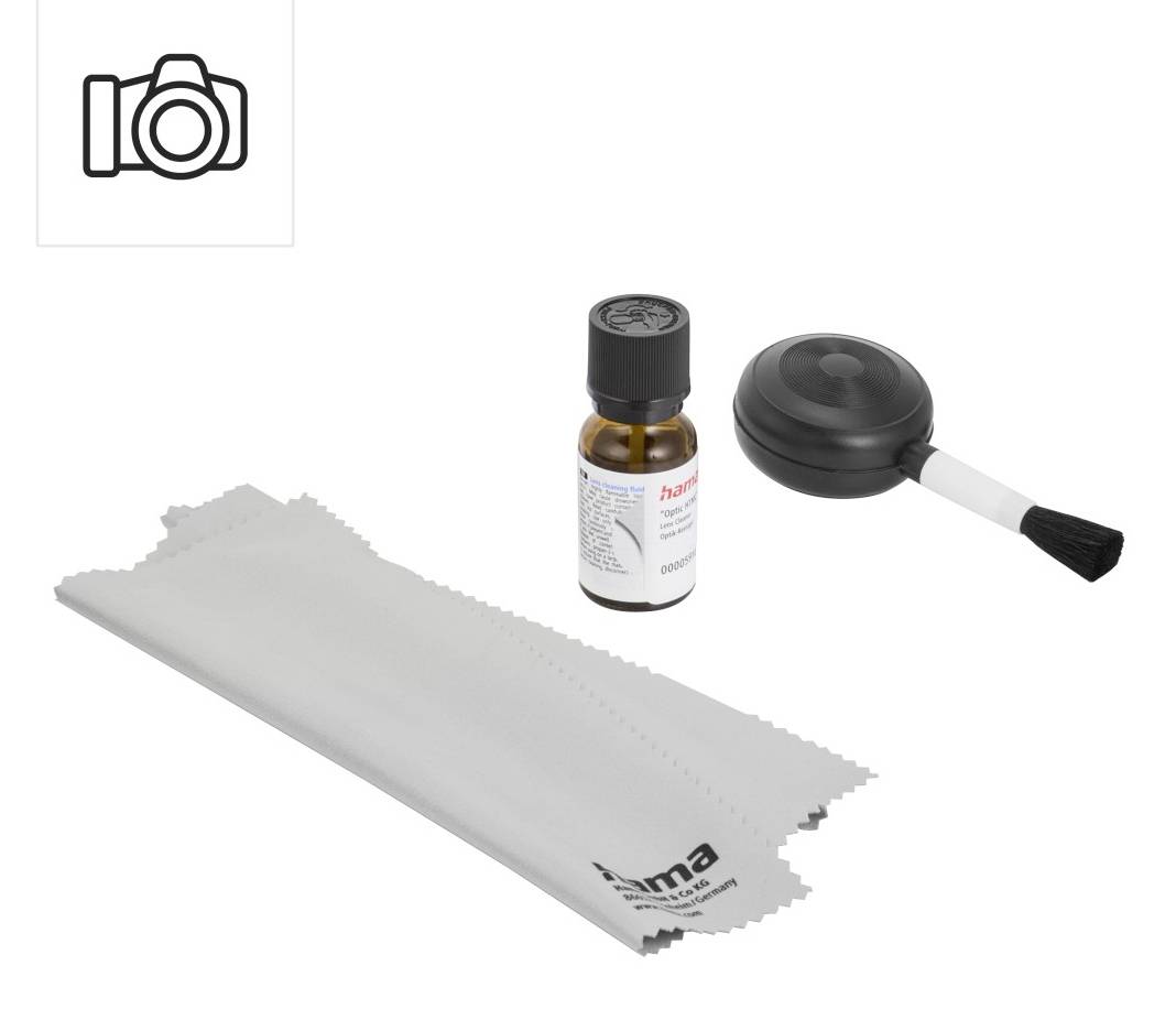 Camera lens cleaning kit with a spray bottle, blower brush, and microfiber cloth on a white background.