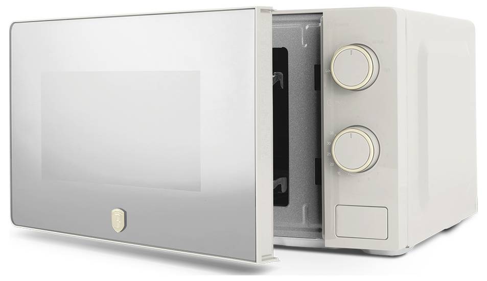 Compact white countertop microwave with glass front, open door, two control dials, and a rectangular button panel.<br>