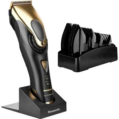 Panasonic electric hair clipper on a charging stand with a set of attachment combs beside it.<br>