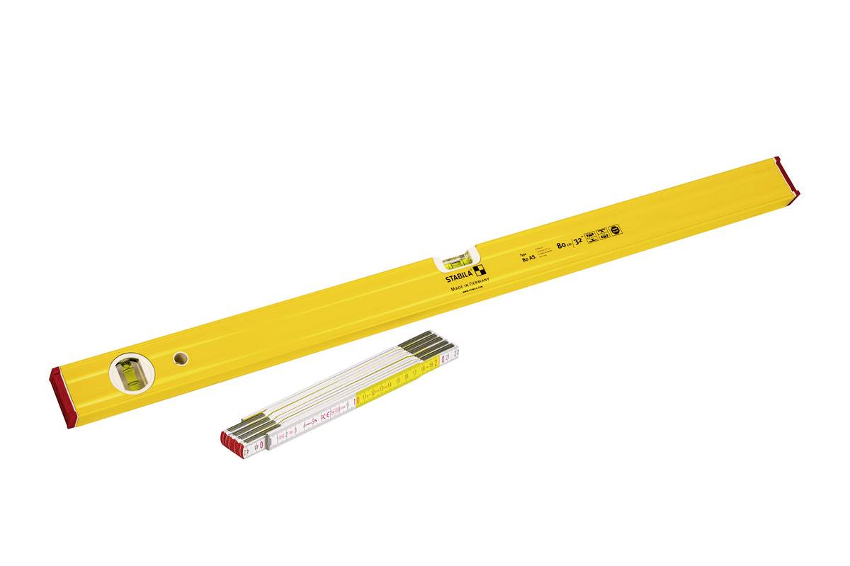 Yellow spirit level with red end caps and built-in vial, shown above a folded measuring rule on a white background.