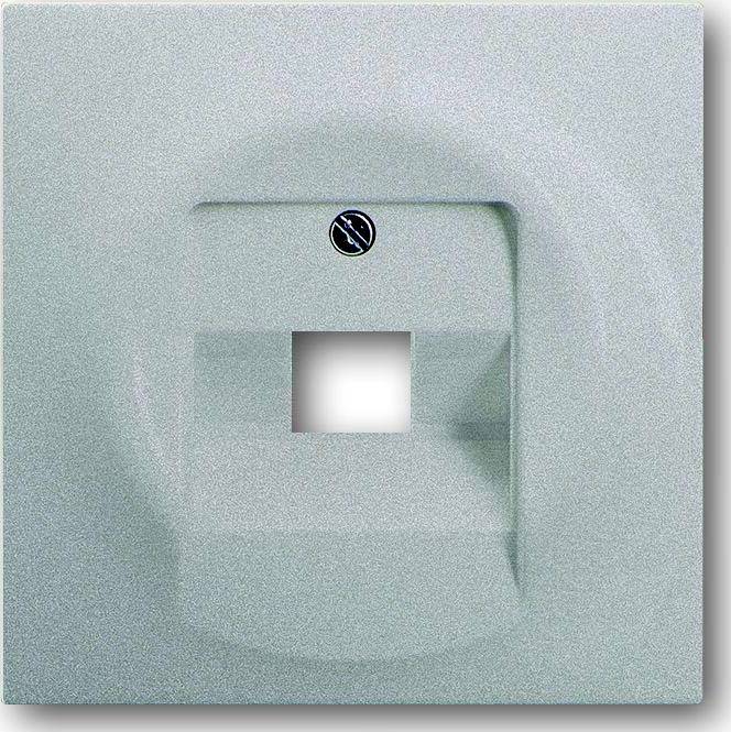 Close-up of a wall plate with a small central square opening and a screw above it, likely a cable or utility port cover.