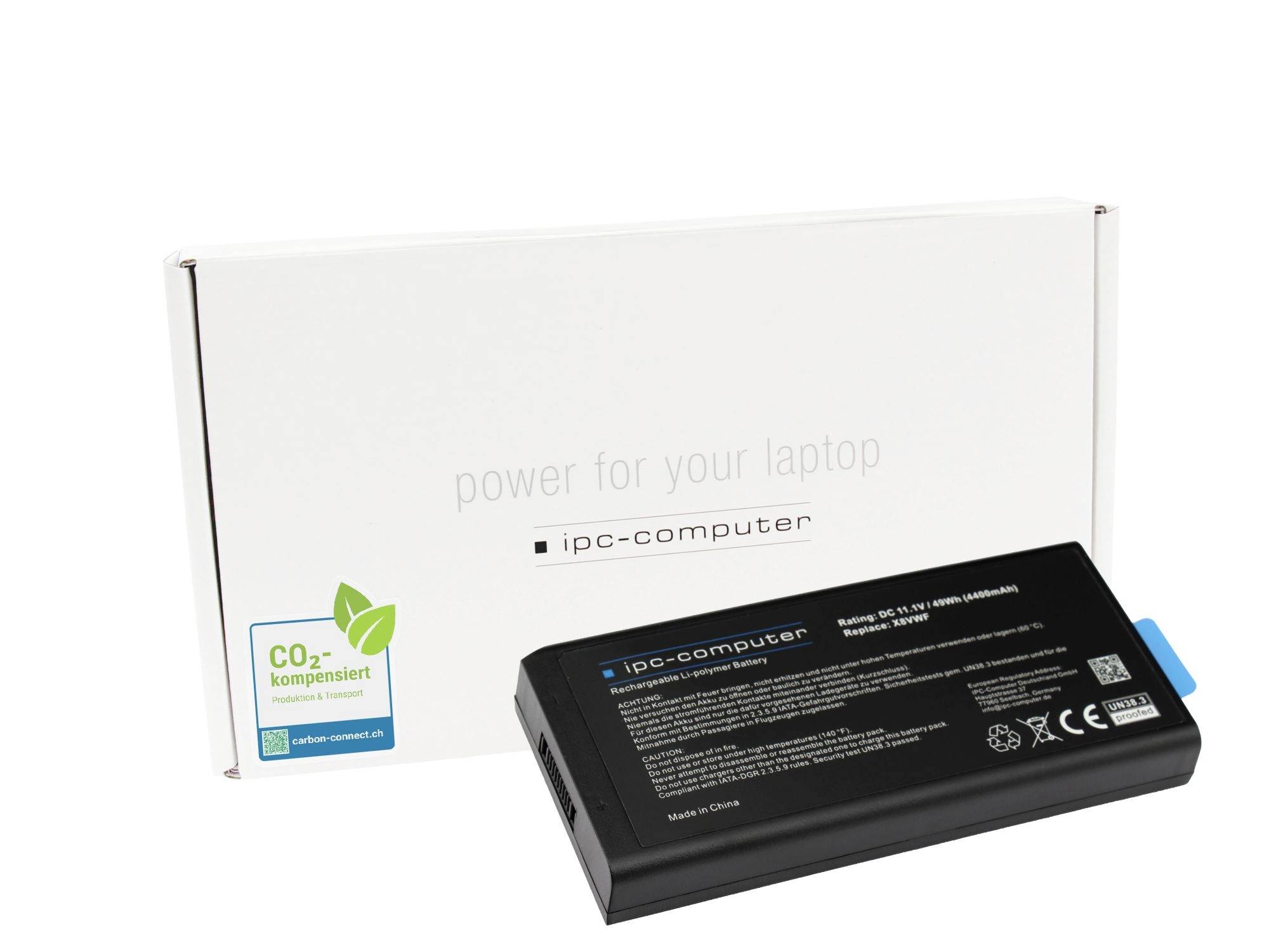 Black laptop battery pack in front of a white IPC-Computer box labeled 'power for your laptop' and 'CO2 kompensiert'.