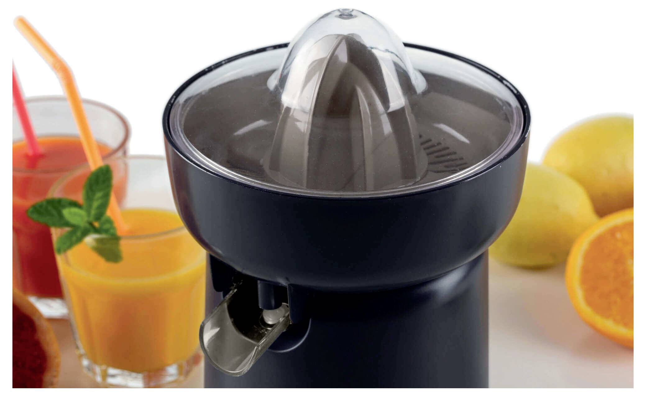 Electric citrus juicer centered with orange and grapefruit halves and glasses of fresh juice on the sides.