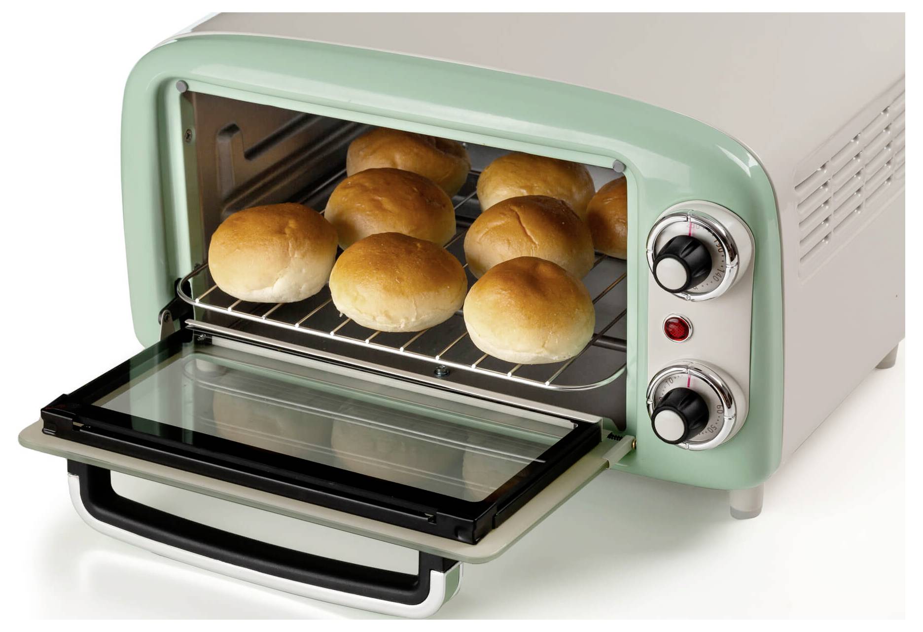Open toaster oven with six bread rolls baking on the rack, door lowered and control knobs visible.