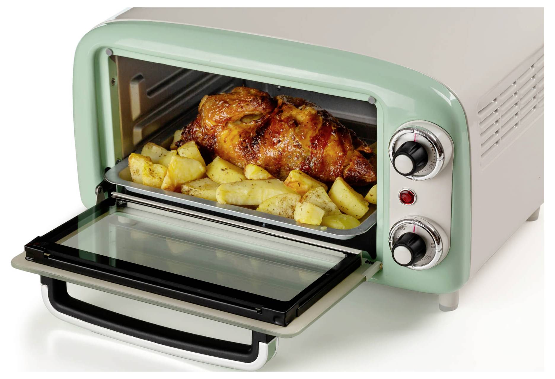 Open countertop toaster oven with a roasted chicken and potato wedges inside on the baking tray.