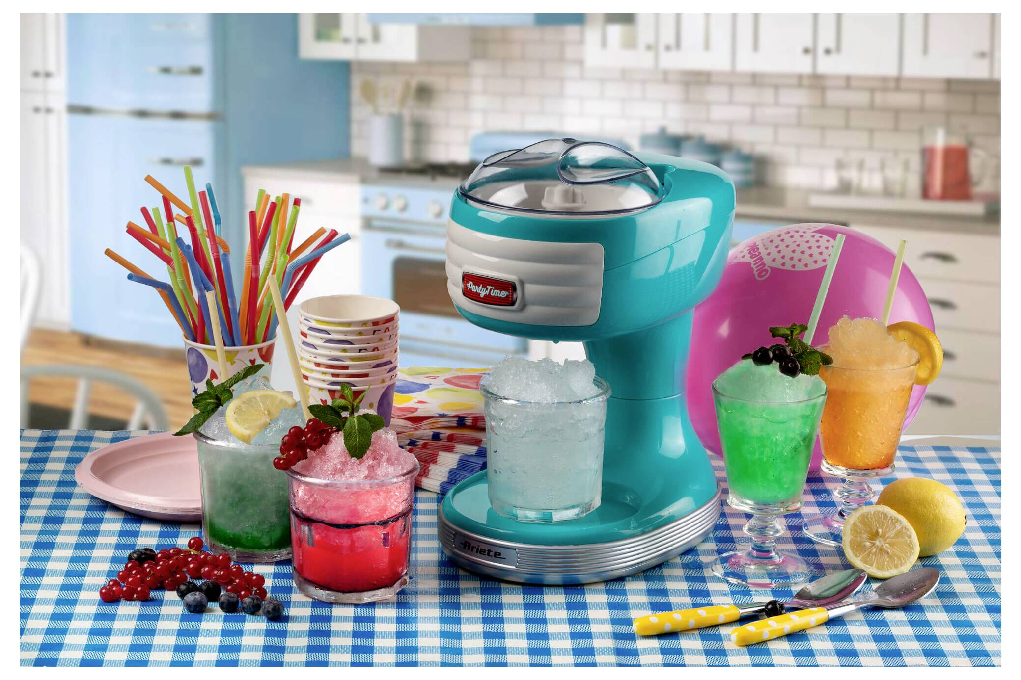 Colorful countertop slush machine with multiple fruit drinks and striped straws on a kitchen table, suggesting a party or refreshment setup.