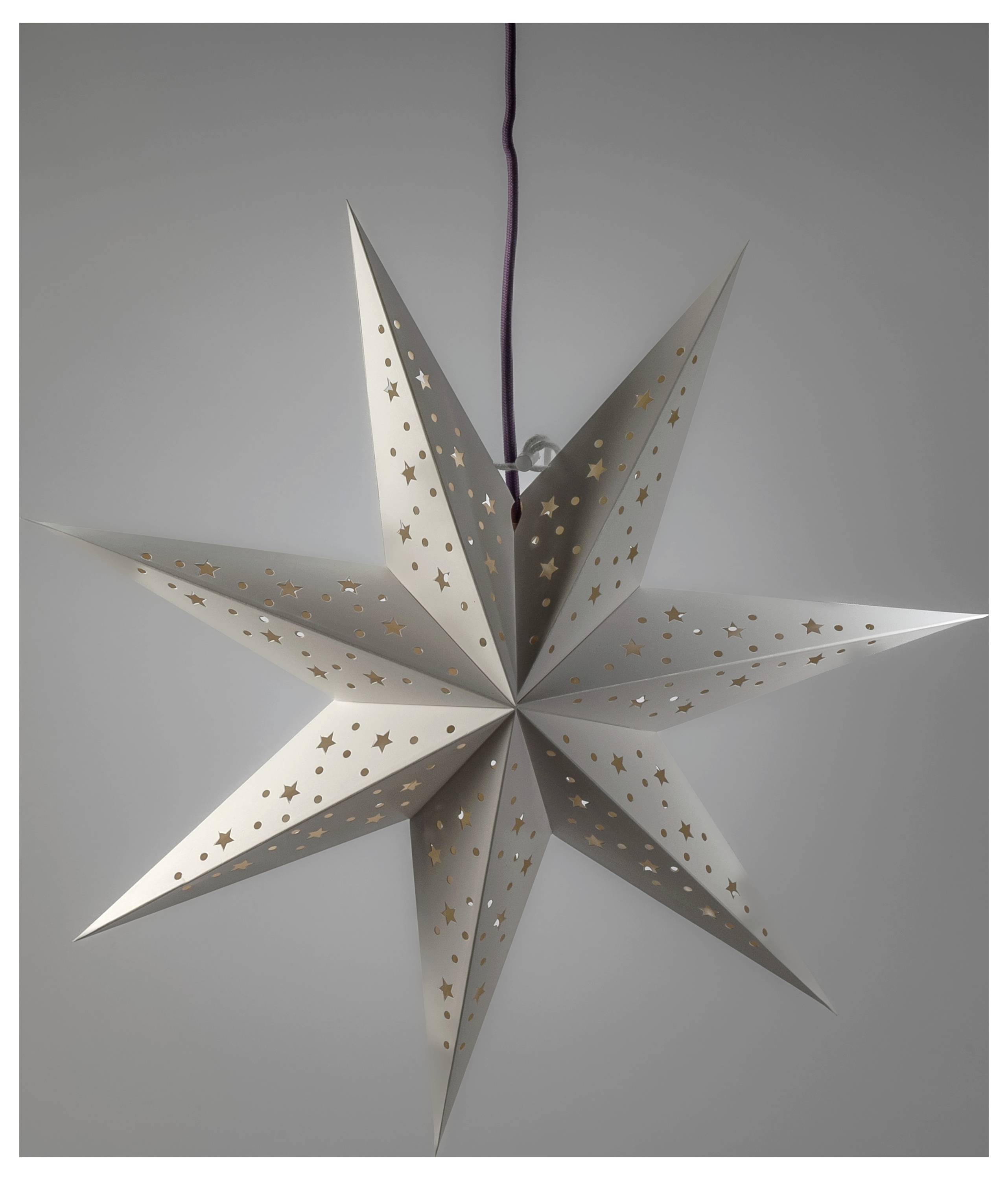 Hanging white paper star lantern with gold star cutouts on a gray wall.