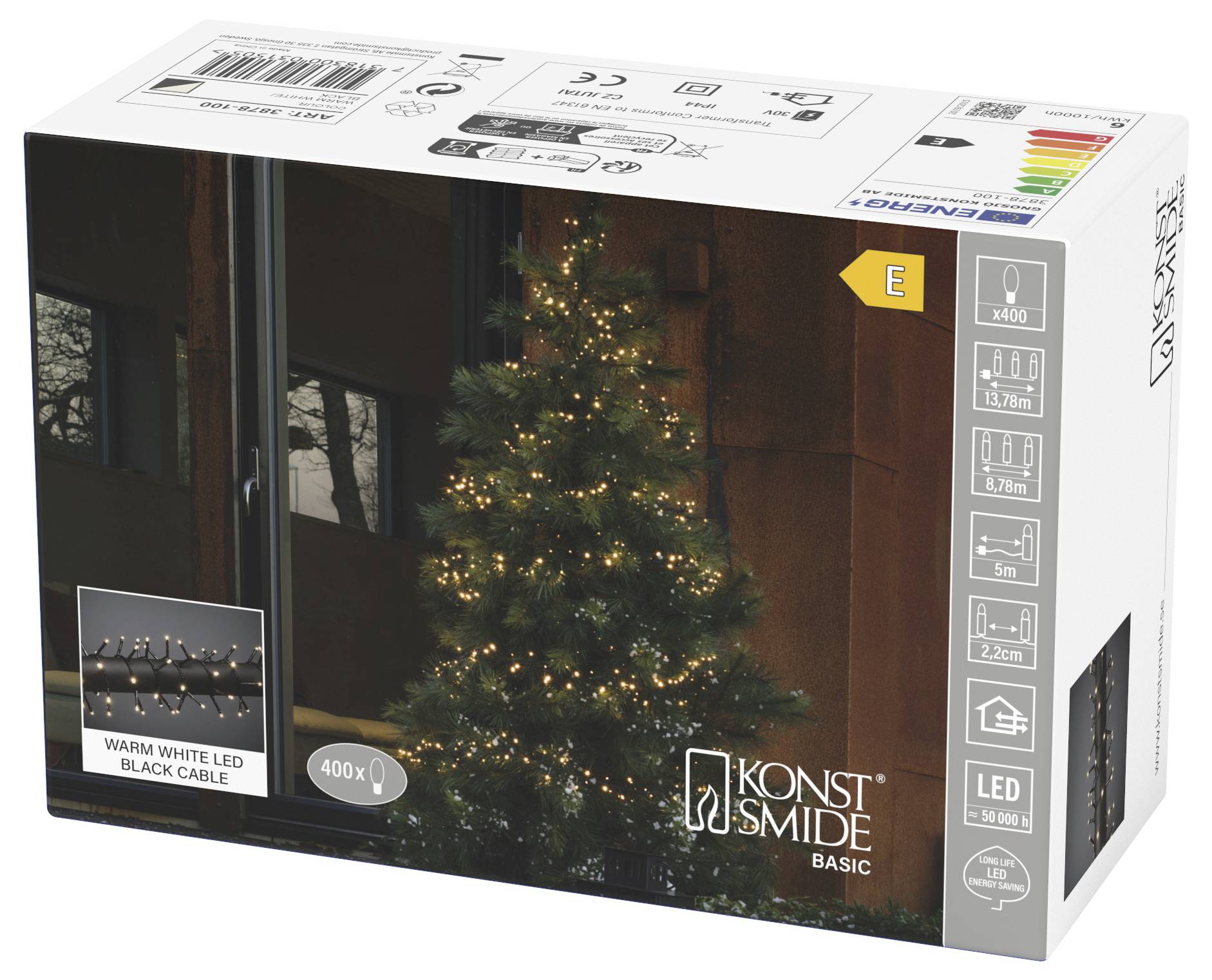 Packaging for Konst Smide Basic warm white LED string lights for indoor/outdoor Christmas tree decoration, showing a lit tree and product specs.