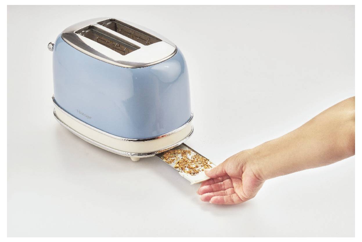 Hand holding a slice of toast being pushed out of a blue toaster on a white surface.