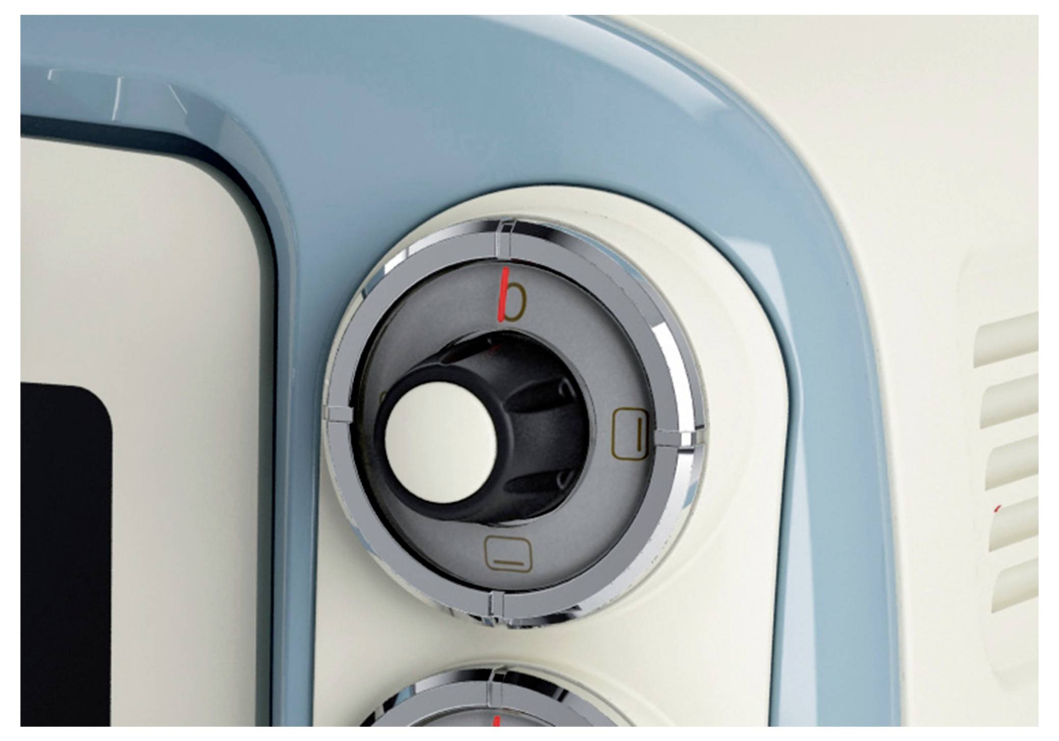Close-up of a medical imaging scanner’s circular control dial, with a red 'b' indicator and small button icons on a white and blue machine panel.