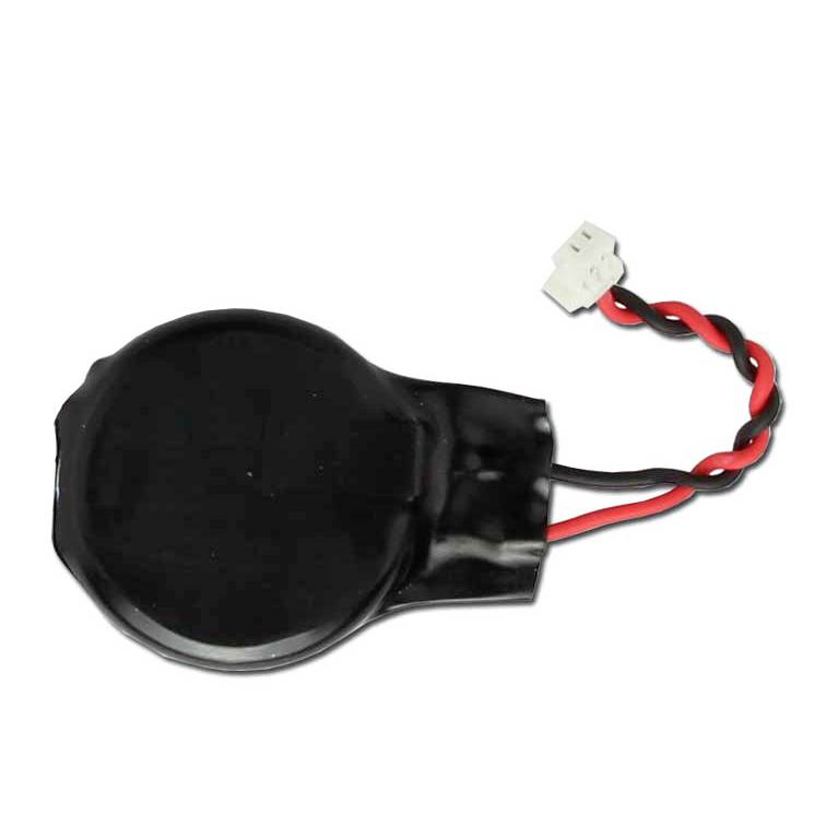 Black coin-cell battery with red and black wire leads and a small white connector<br>