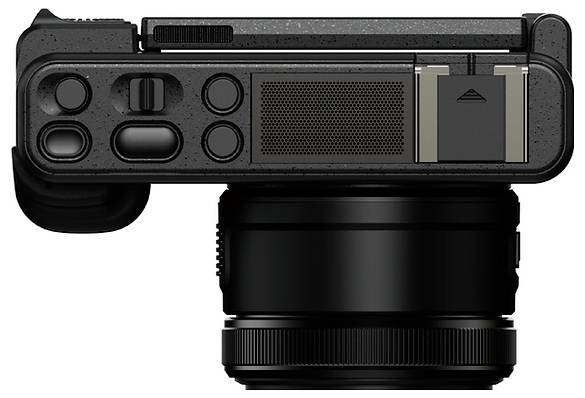 Compact black camera with a large lens and top control panel, shown front view on a plain white background.