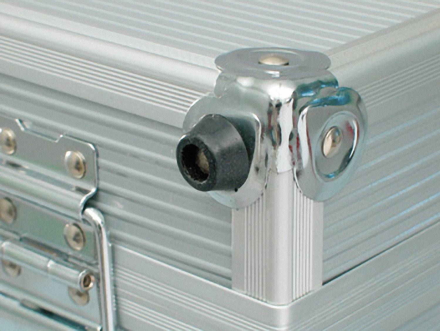 A metal and rubber corner protector attached to a silver aluminium case shows details of the construction method.