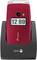 Red flip mobile phone on charging station, displaying time as 12:00.