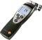 A portable moisture metre displays '1.4%' on its screen. It is used for measuring material moisture content.